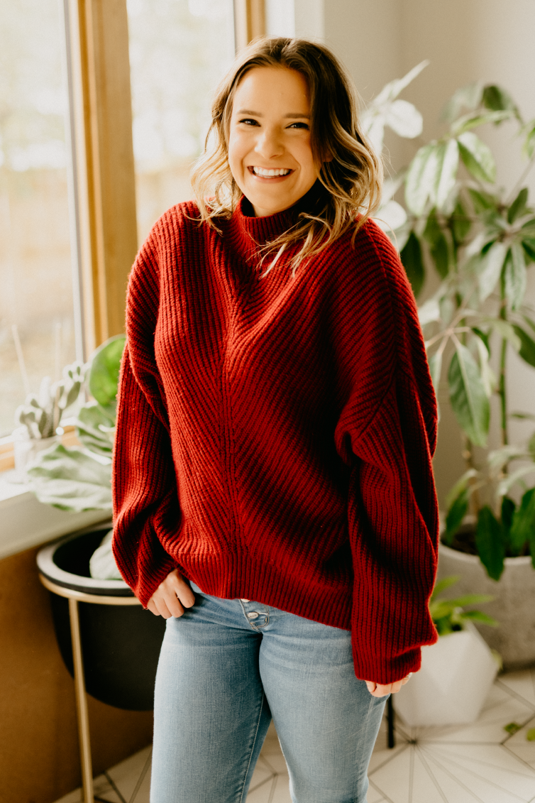 Sara Nelson wearing a red sweater 